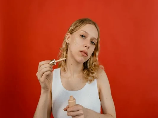 Makeup artist applying foundation on mature skin using expert blending techniques