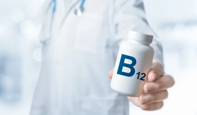 Illustration showing the vital role of vitamin B12 in nerve health, red blood cell production, and DNA synthesis.